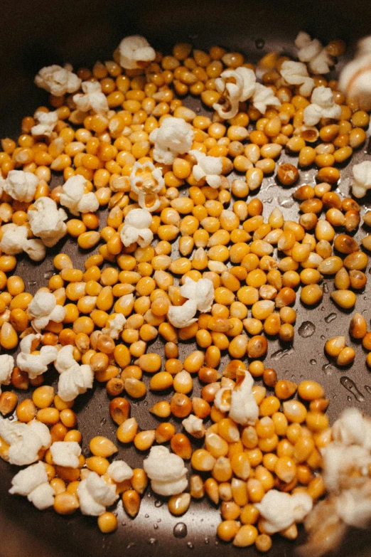 a metal pot with some tiny yellow and white vegetables in it