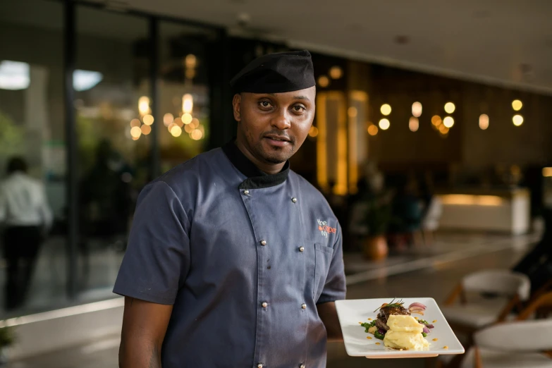 a man holding a plate of food at an event