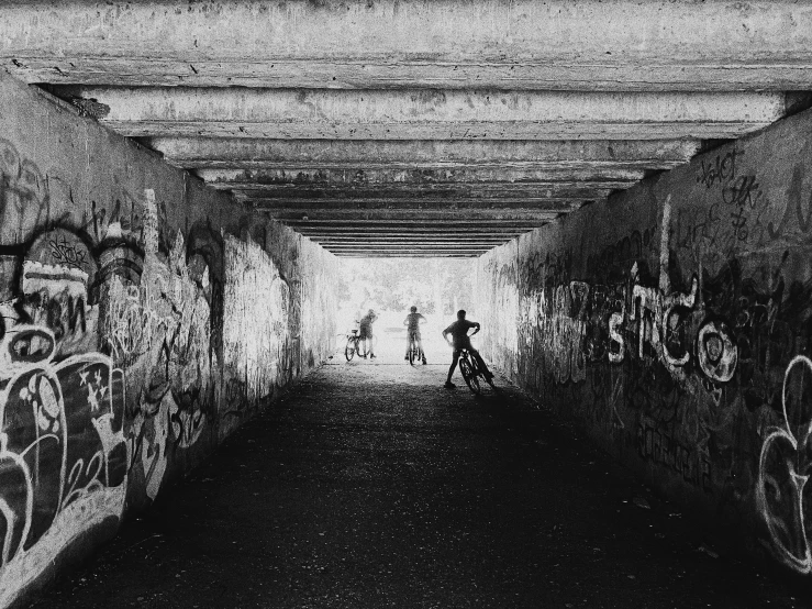 a black and white po of a person in the middle of a long tunnel