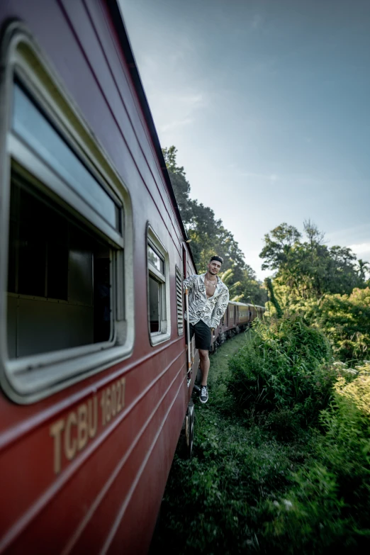 a man is leaning on the side of a train