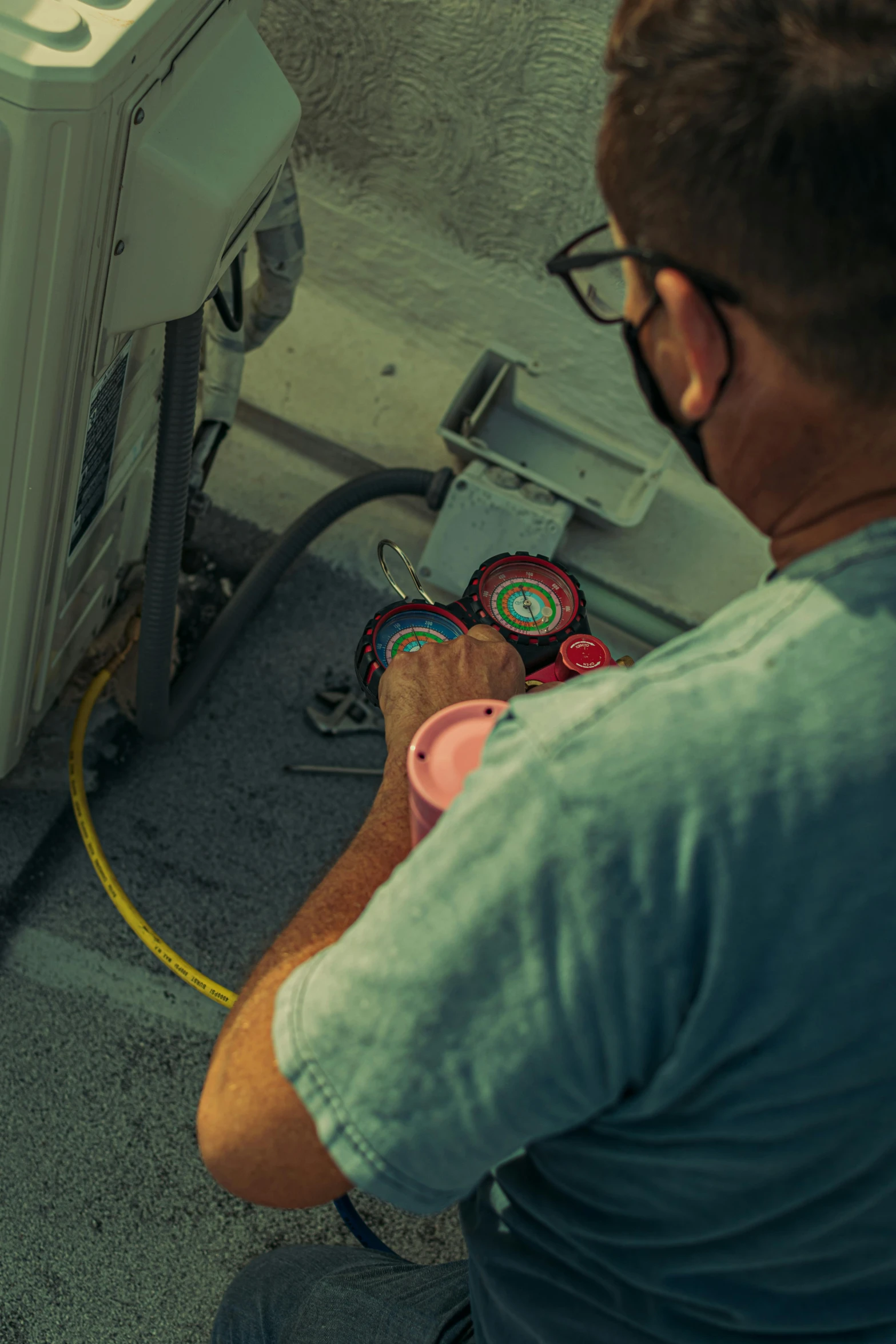 a man holding onto an object that is connected to a fire hydrant