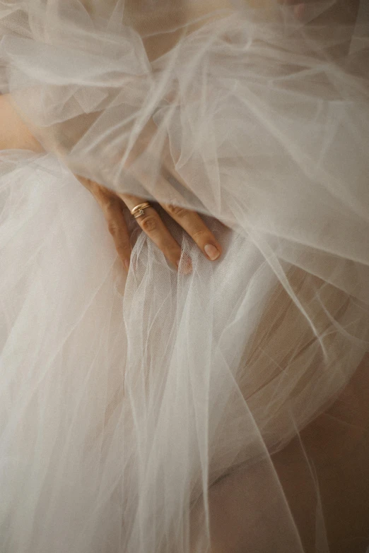 a woman is wearing a wedding dress with a band on it