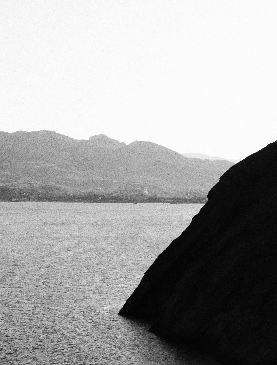 a black and white po of mountains and the ocean