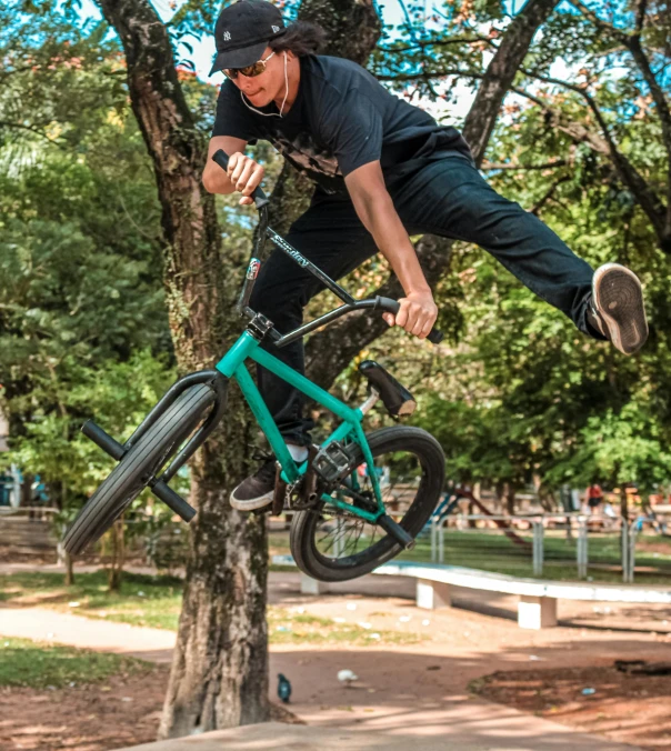 a man jumping in the air while riding a bike