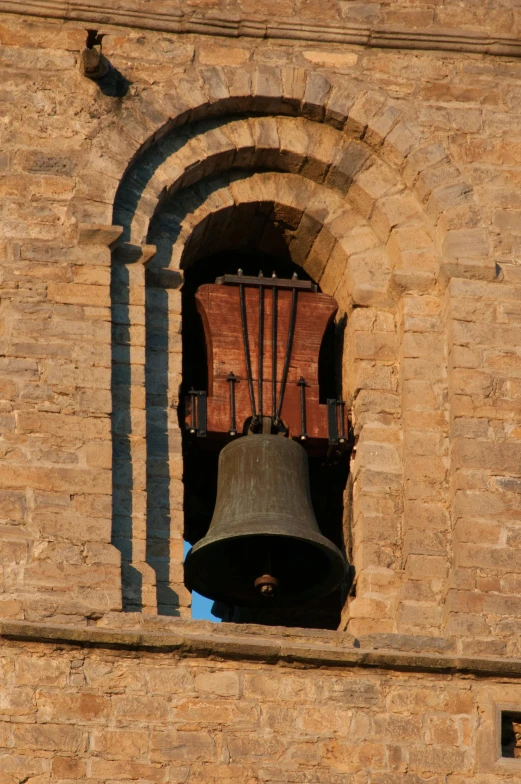 a bell inside a stone tower on top of a building