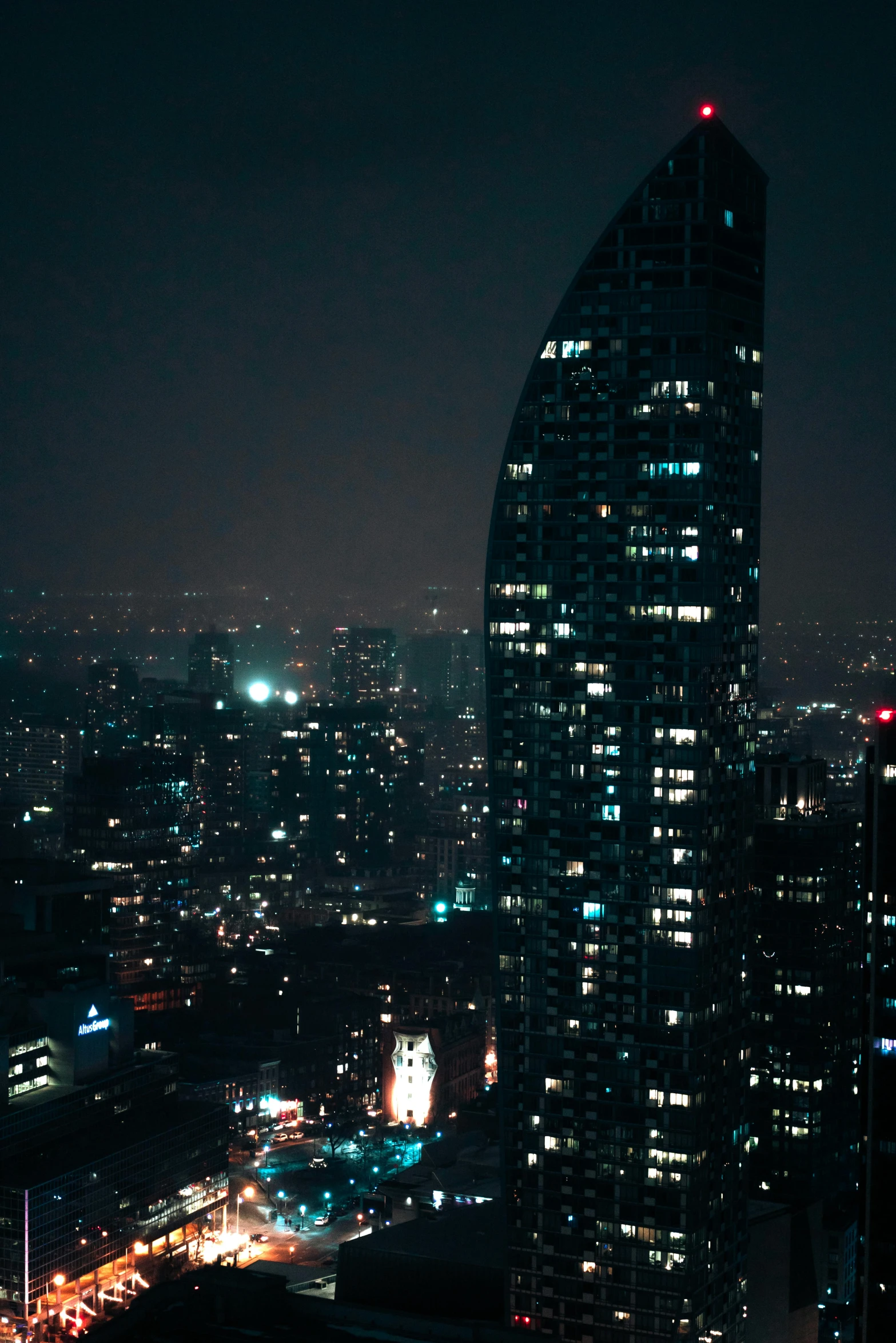 some very tall buildings in a big city at night