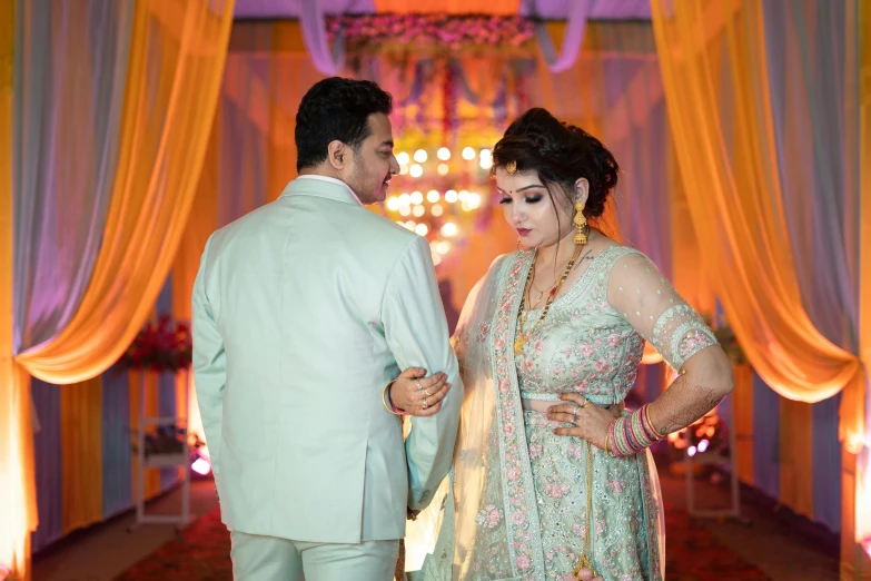 a bride and groom look into each others eyes