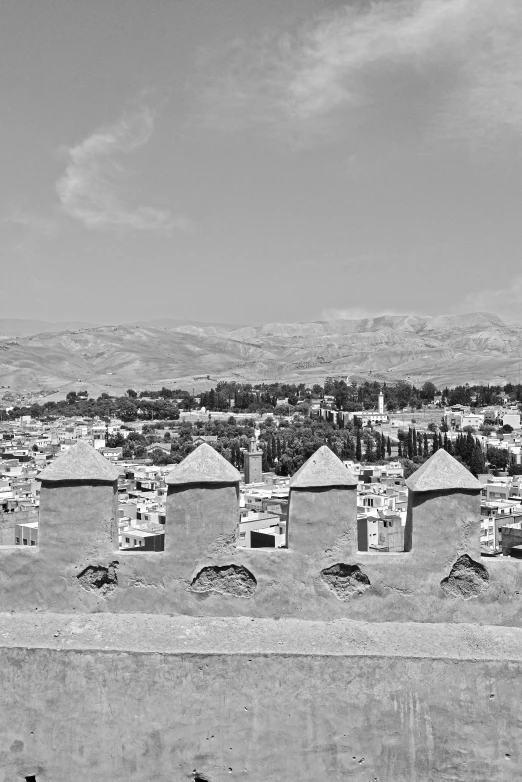 an aerial view of the city skyline with buildings and mountains