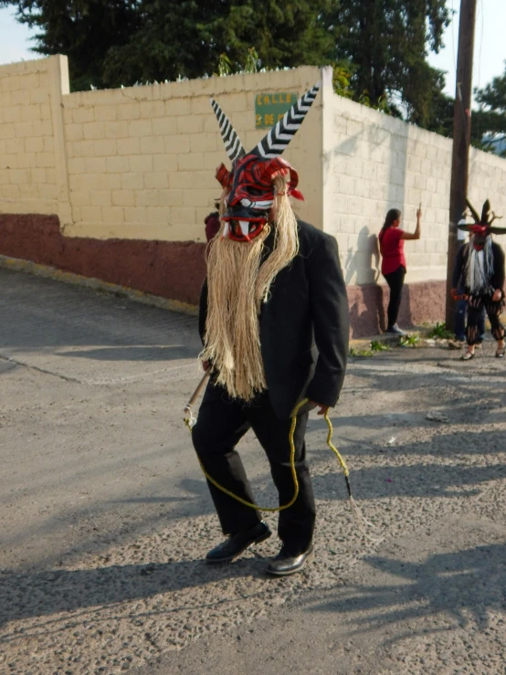 man in weird mask walking down the street