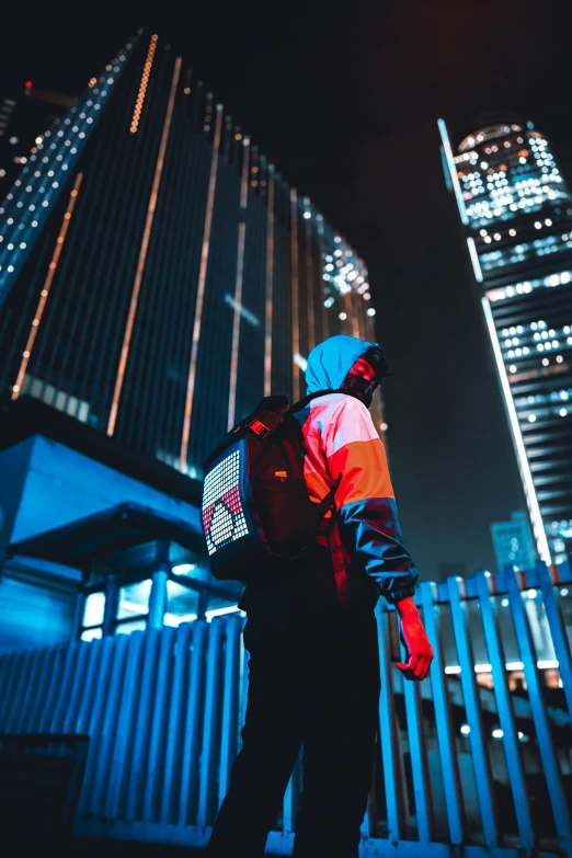 a man standing outside in front of some tall buildings