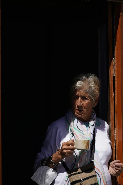 woman standing with handmade bag and coffee