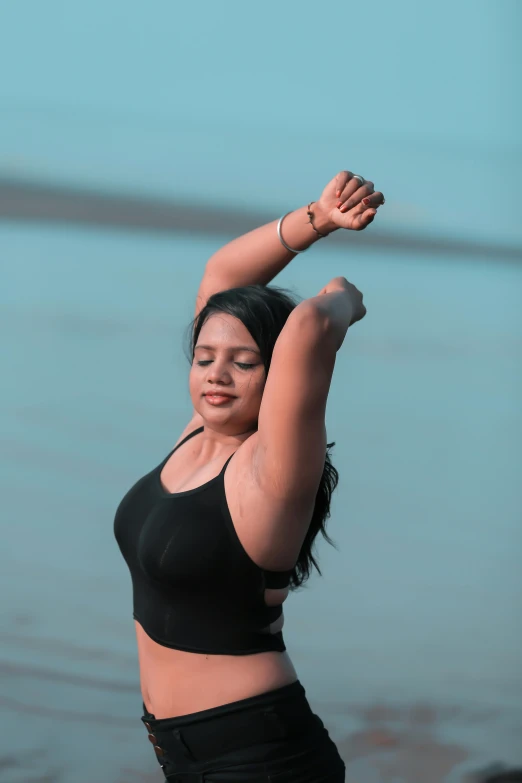 the woman is standing near a body of water