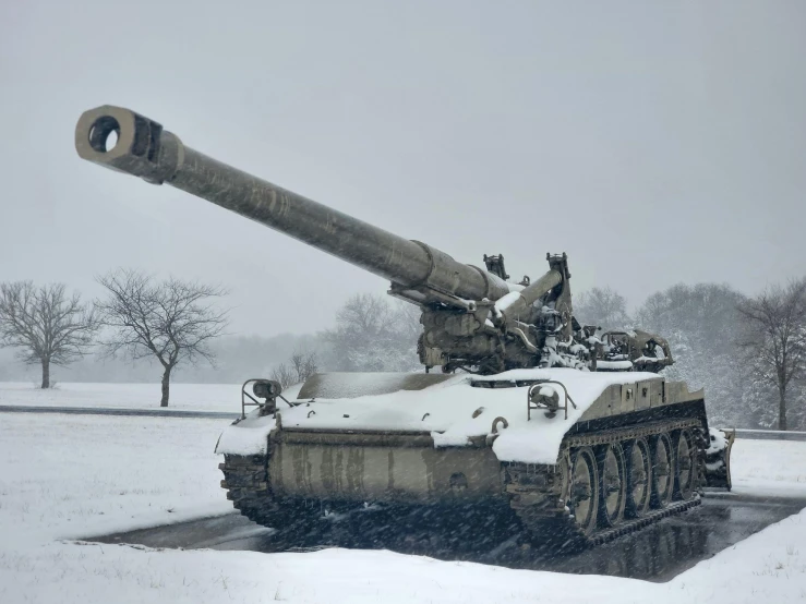 old, vintage tank sitting on a snowy surface