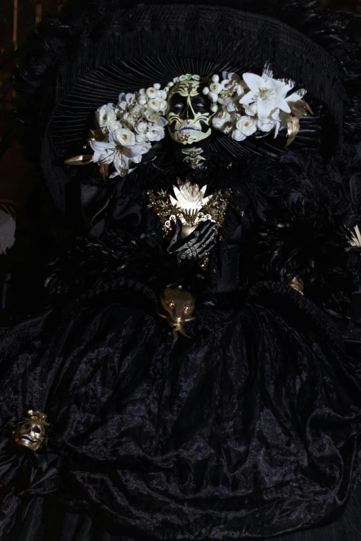 the woman is in black gown with flowers