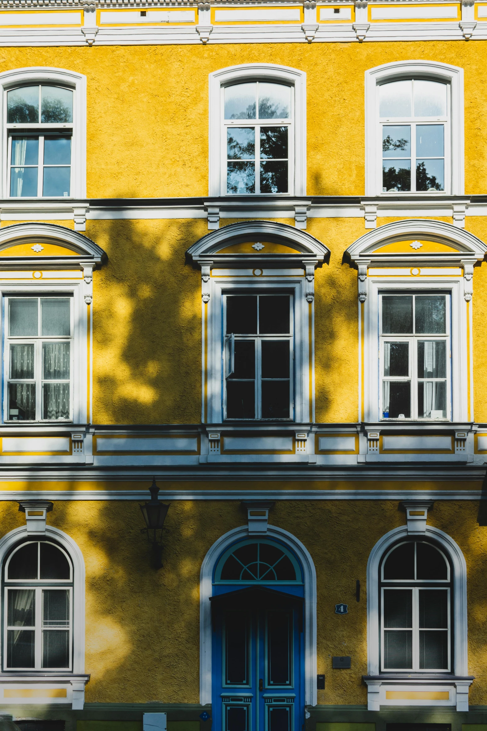 a picture of a building with two windows and three arched doors