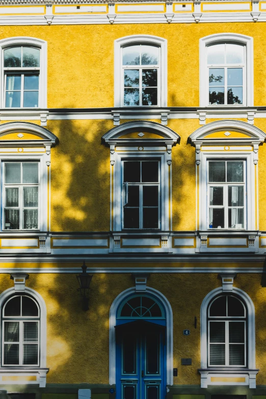 a picture of a building with two windows and three arched doors