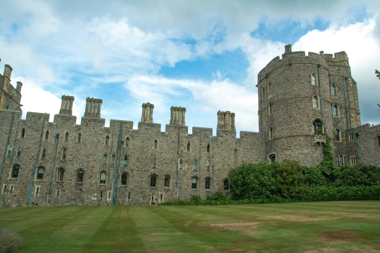 a castle in the distance against a cloudy blue sky