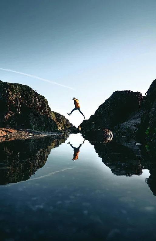 an image of a lake with birds flying over it