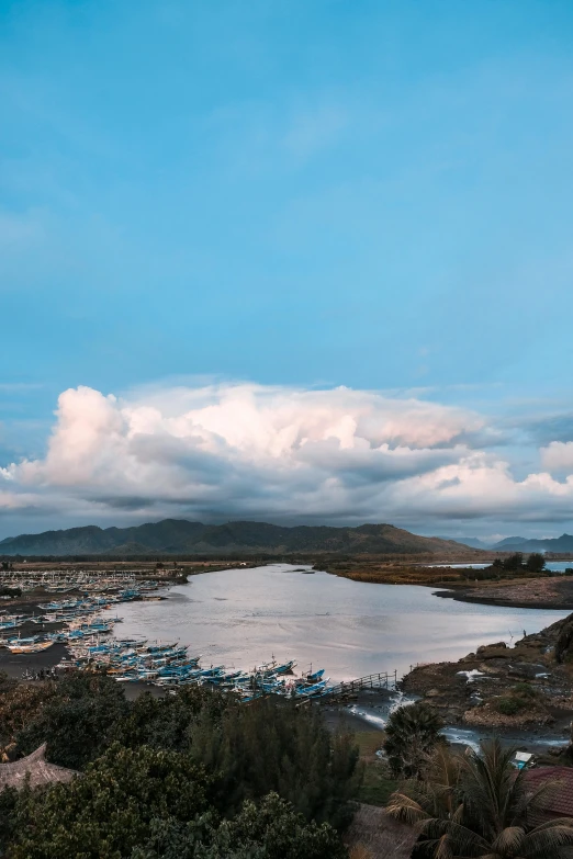 there are some clouds above the city and water