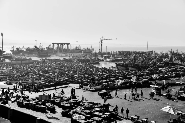 a black and white po of people walking and looking at an ocean