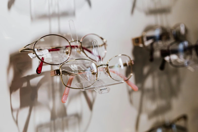 a display of glasses hanging on a glass wall