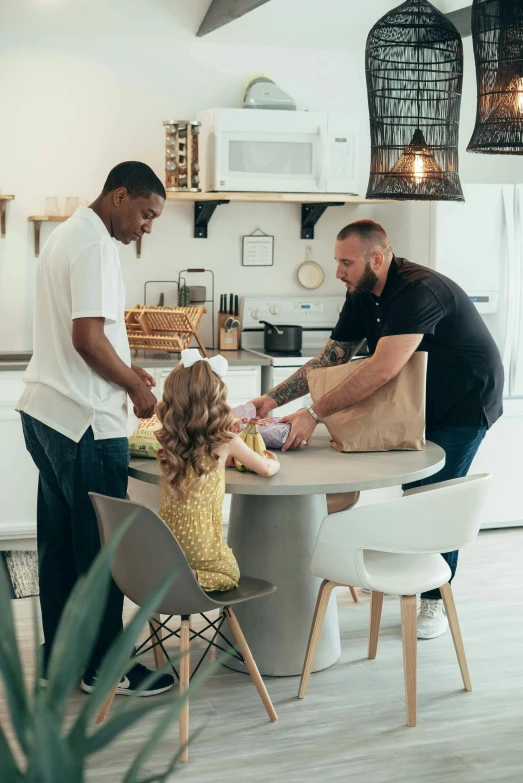 people at a kitchen table in front of the counter