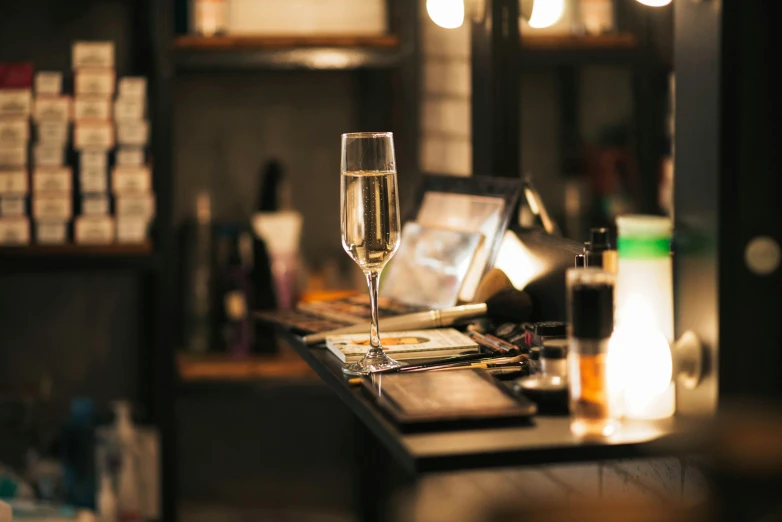 a glass of wine sits on top of a bar