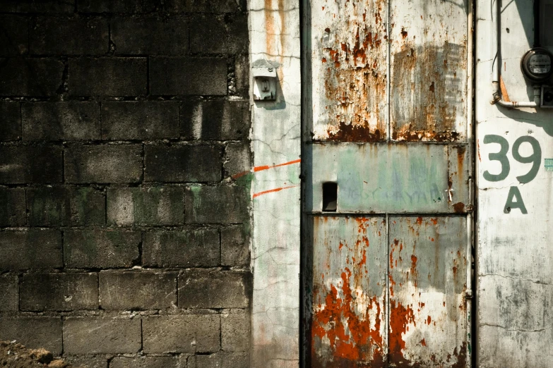 an open door sits against a brick wall