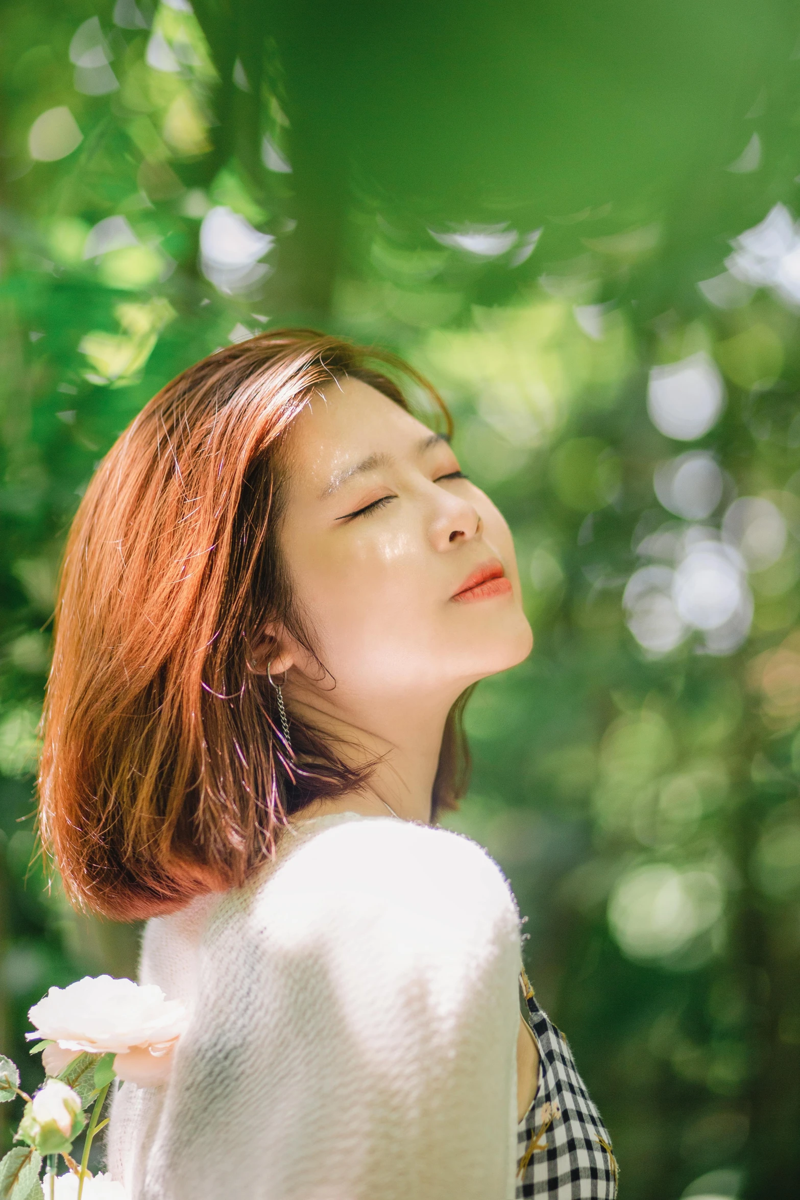 the young woman has red hair and is looking up