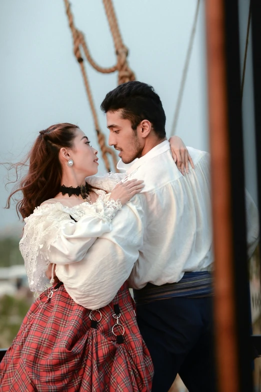 a man is kissing a woman wearing a skirt and white shirt