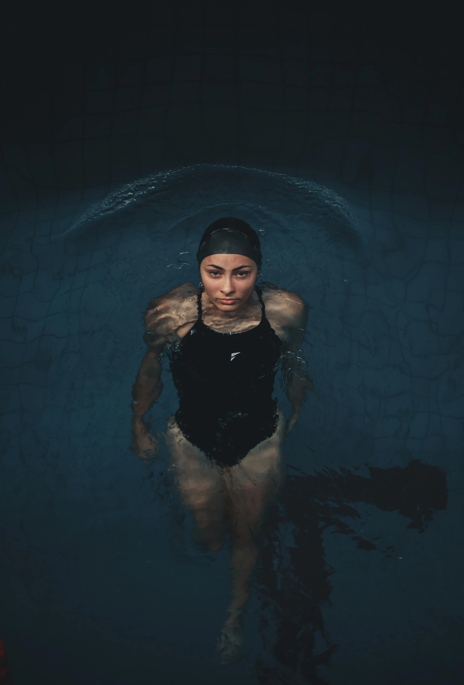 a woman wearing a swimsuit in a body of water