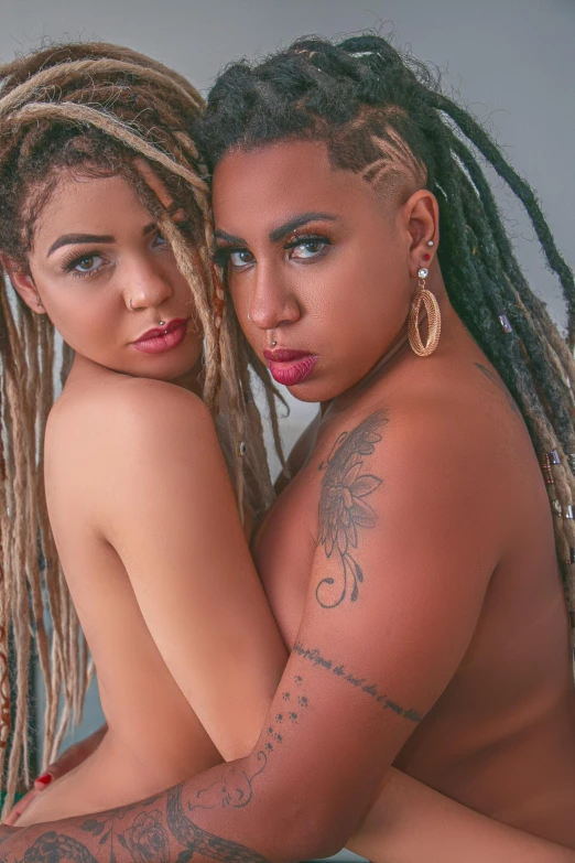 two beautiful women with dreadlocks on each of their bodies