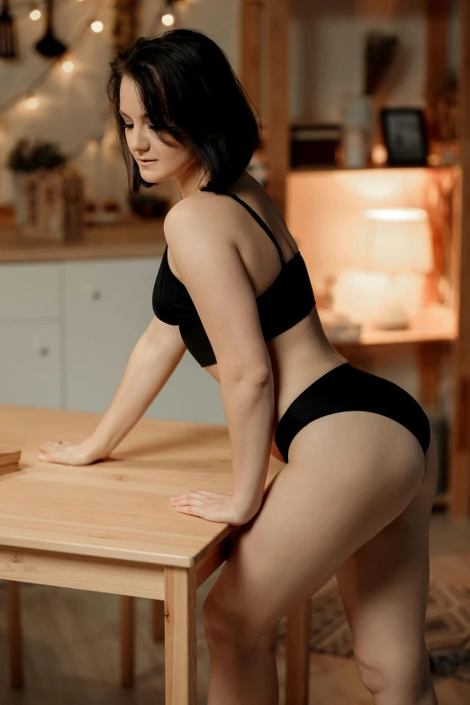 a woman in a bikini sitting at a table
