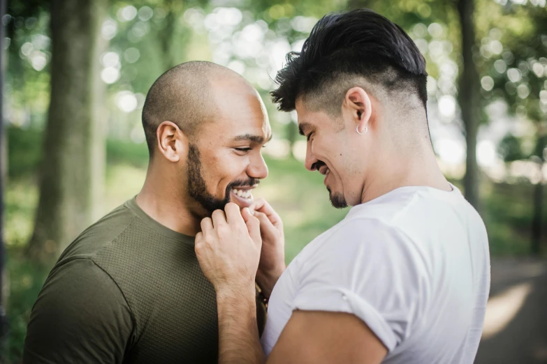 two men laughing together, one is holding another