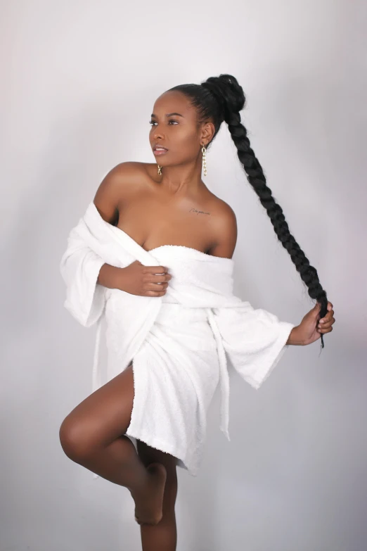 a woman is wearing a white towel and posing