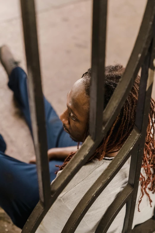 a girl laying on the ground while reading soing