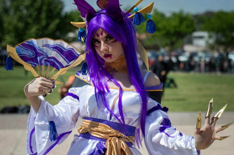 a woman with purple hair and blue eyes dressed as a fairy