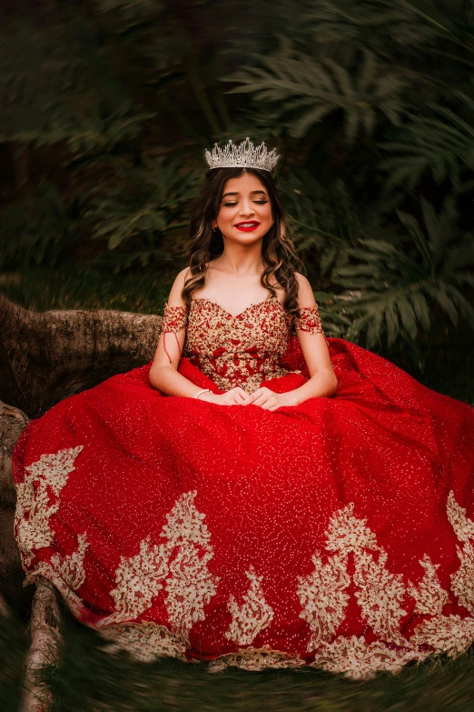 a woman is sitting down wearing a dress