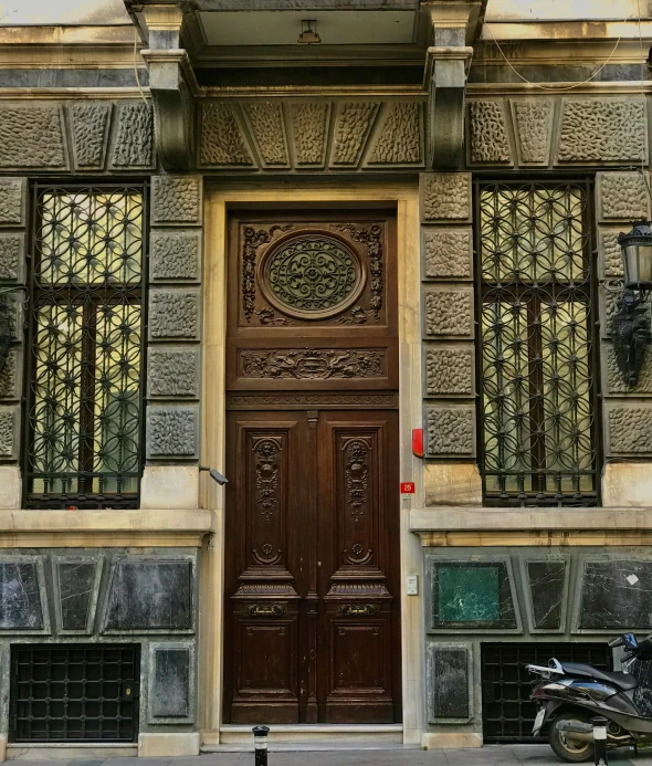 a motorcycle parked next to an ornately carved doorway