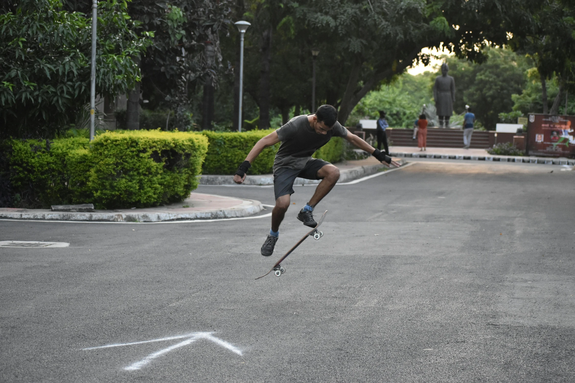 a man riding a skateboard through the air on top of concrete