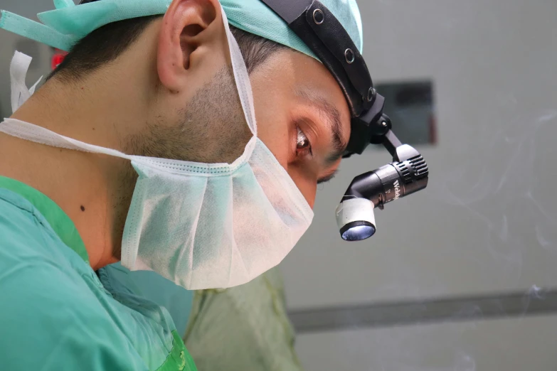 a dentist examines a male patient's eye