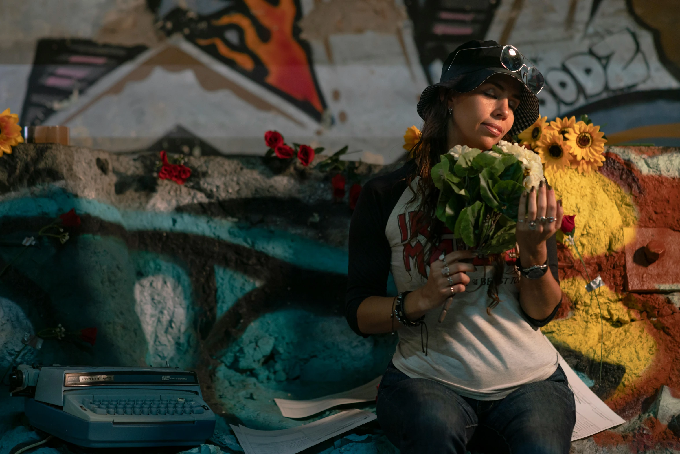 a woman holds flowers while posing for the camera