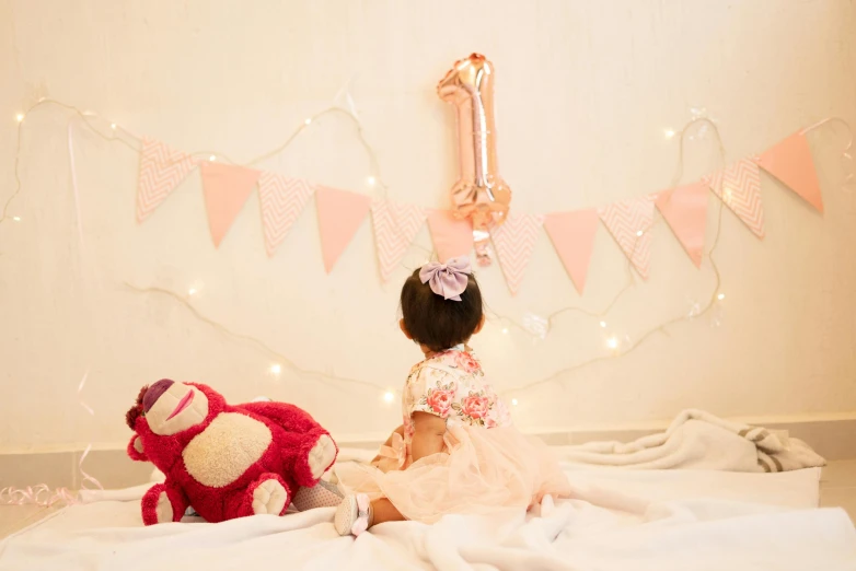 an image of a young child that is sitting with her teddy bear