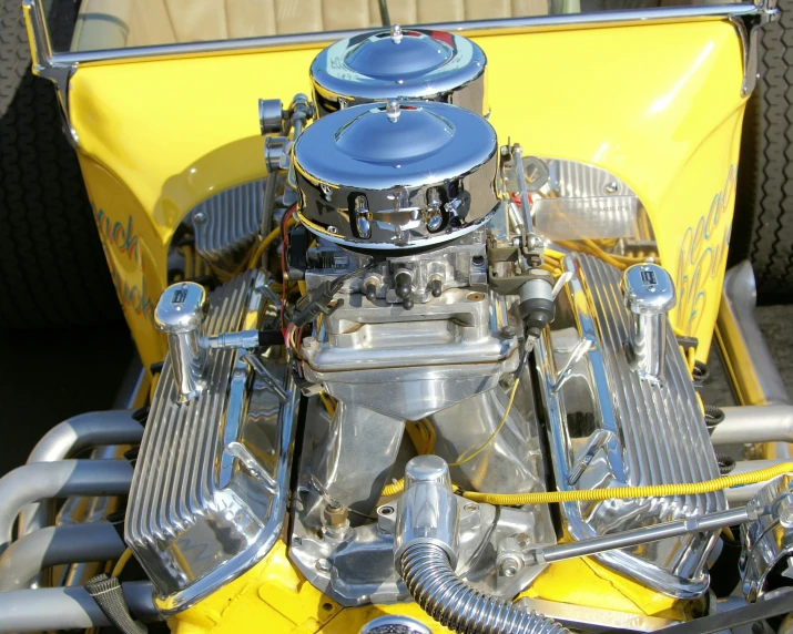 the yellow and black engine of an antique vehicle