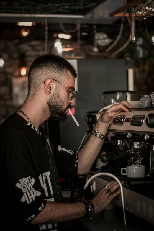 a man smoking and staring into a machine