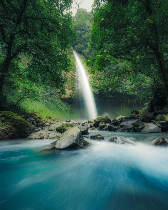 the waterfall is in the middle of the water