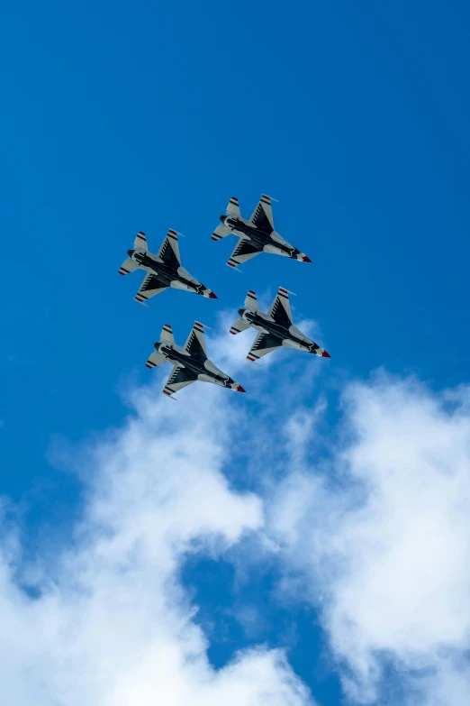 five jets flying in formation against a blue sky