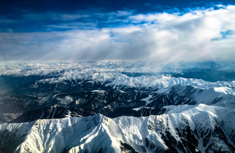 the clouds are blowing over the mountains