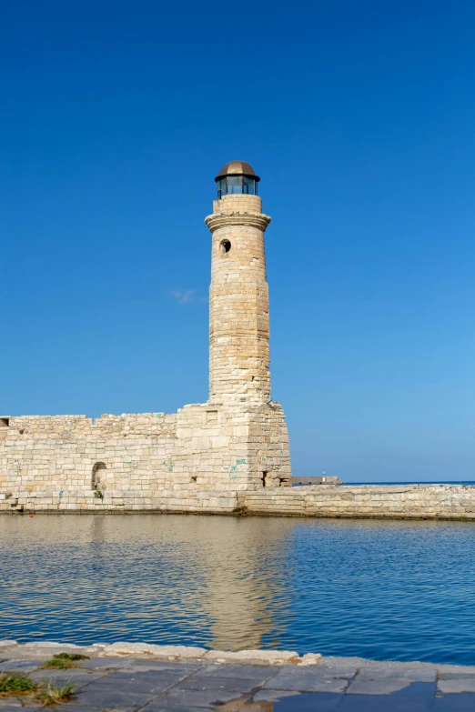 lighthouse along river with light water in foreground