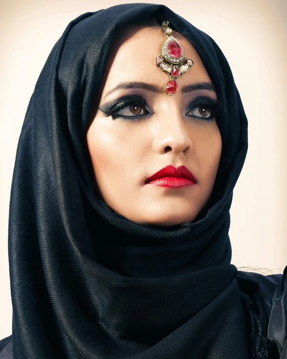 a woman in a headdress and red lipstick